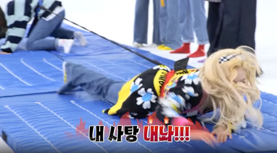 Handong moving towards the candy tray while Dami is on her knees recovering from being pulled away form her side of the mat