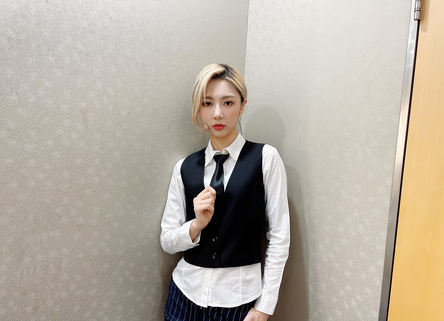 Yoohyeon wearing a vest and tie